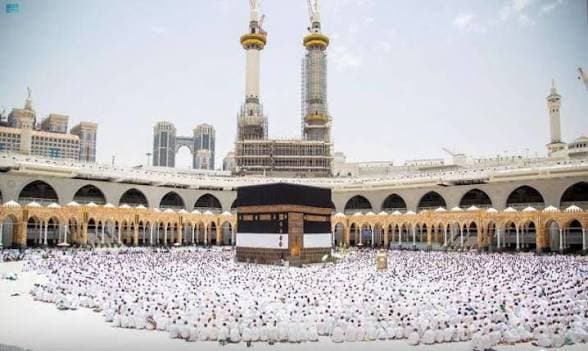 Pilgrims in white ihram surround the Kaaba at the Grand Mosque in Mecca.